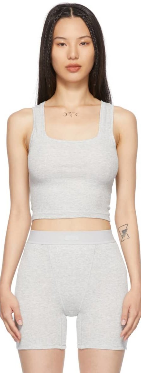Sleeveless rib knit stretch cotton tank top in grey. Scoop neck collar. Tonal textile logo patch at back collar. Cropped hem.
